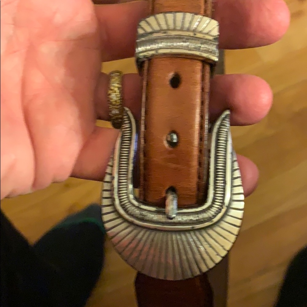 Men’s brown leather belt with silver fittings.